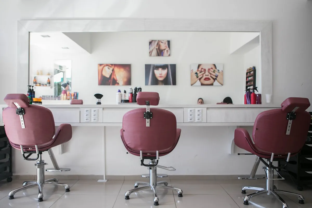 Inside Creations salon - modern styling stations with warm, welcoming atmosphere